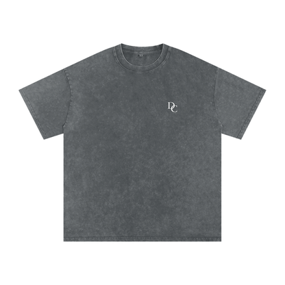 Don Chevere Asphalt Oversized Essential Tee, a washed charcoal grey 100% cotton t-shirt with a subtle white DC logo on the left chest.