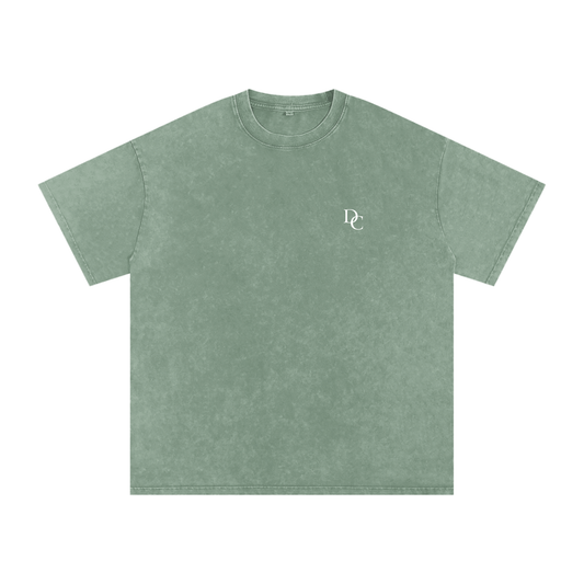 Don Chevere Asphalt Oversized Essential Tee, a washed green 100% cotton t-shirt with a small white DC logo on the chest.