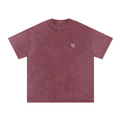 Don Chevere Asphalt Oversized Essential Tee, a washed maroon 100% cotton t-shirt with a subtle DC logo on the left chest.
