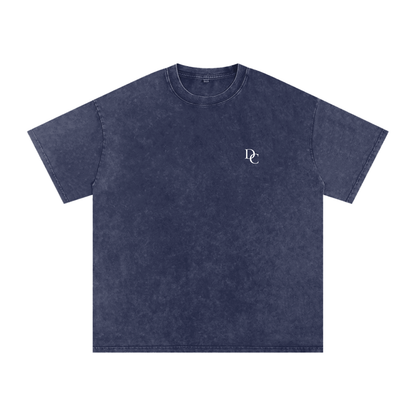 Don Chevere Asphalt Oversized Essential Tee, a washed navy blue 100% cotton t-shirt with a relaxed fit and small white DC logo on the left chest.