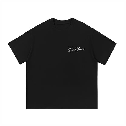 Don Chevere black 100% cotton unisex short sleeve t-shirt with a white embroidered logo on the left chest.