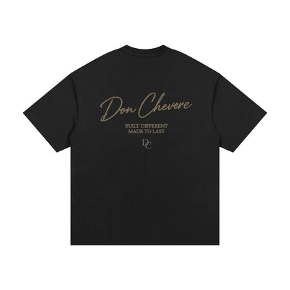 Don Chevere black 100% cotton oversized heavy tee with gold text graphic on back.