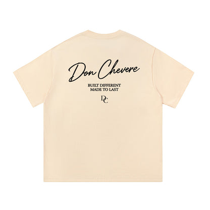 Don Chevere cream 100% cotton unisex short sleeve t-shirt with round neck and black graphic print on back.