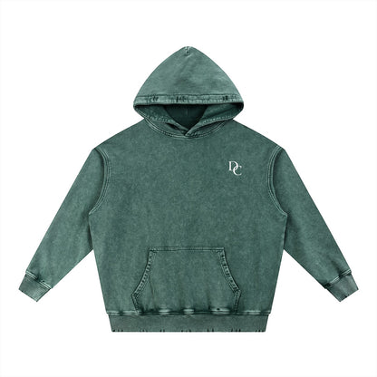 Don Chevere Asphalt Distressed Heavyweight Hoodie in a faded green color, made of 100% cotton with a distressed finish and a front pocket.