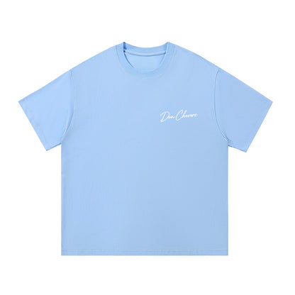 Don Chevere light blue 100% cotton unisex t-shirt with short sleeves and round neck, featuring a white script logo on the chest.
