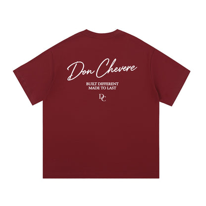 Don Chevere maroon 100% cotton unisex short sleeve t-shirt with white text graphic on back.