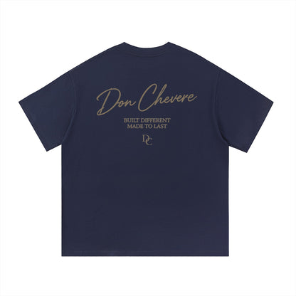 Don Chevere navy blue 100% cotton unisex short sleeve t-shirt with gold text graphic on back.