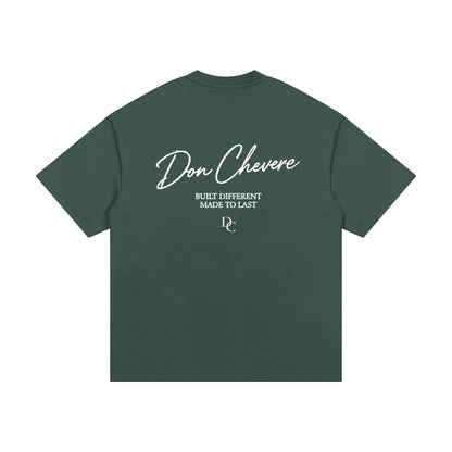 Don Chevere oversized heavy tee in dark green, made of 100% cotton with white text graphic.