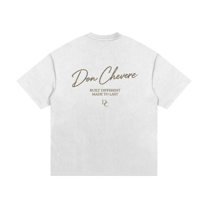 Don Chevere oversized heavy tee in gold, made of 100% cotton with a round neck and short sleeves. Features a graphic print on the back.