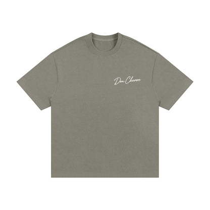 Don Chevere oversized heavy tee in a muted green color. Made of 100% cotton with a crew neck and short sleeves.