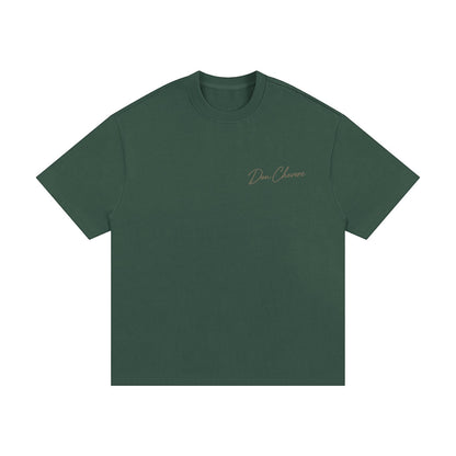 Don Chevere Essential Oversized Heavy Tee in dark green, made of 100% cotton with a relaxed fit and drop shoulders.