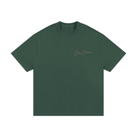 Don Chevere Essential Oversized Heavy Tee in dark green, made of 100% cotton with a relaxed fit and drop shoulders.