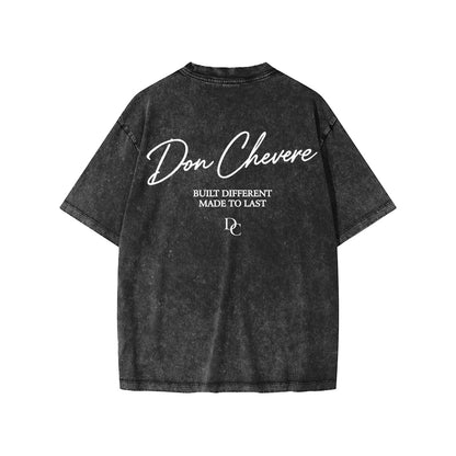 Don Chevere snow washed black 100% cotton kids' short sleeve tee with white text graphic.