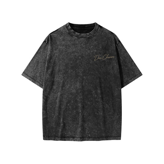 Don Chevere snow washed black 100% cotton kids' short sleeve t-shirt with round neck and subtle gold logo.