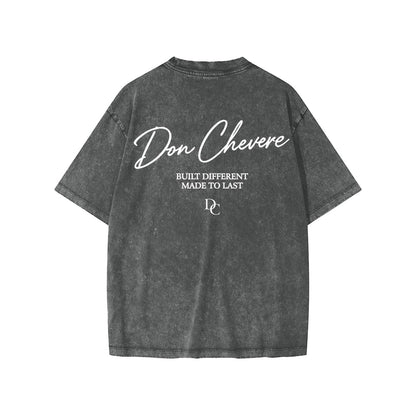 Don Chevere snow washed kids' tee, charcoal grey 100% cotton with white text graphic on back.