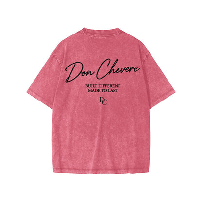 Don Chevere snow washed kids' tee in pink, 100% cotton with black text graphic on back.