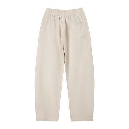 Don Chevere vintage wash loose sweatpants in beige cotton with elastic waist, drawstring, and back pocket.