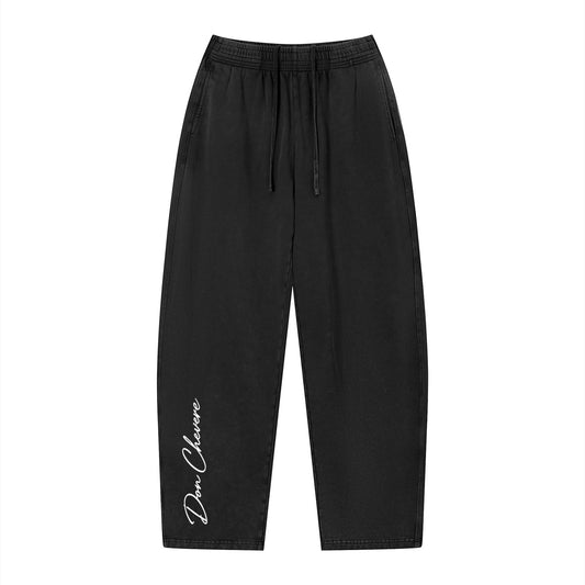 Don Chevere vintage wash loose sweatpants in black cotton with drawstring and side pockets. Unisex casual style.
