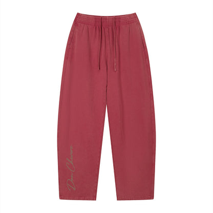 Don Chevere vintage wash loose sweatpants in red, made of 100% cotton with an elastic drawstring waist and side pockets.