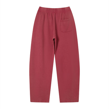 Don Chevere vintage wash loose sweatpants in a dusty rose color, made of 100% cotton with an elastic waistband and a single back pocket.