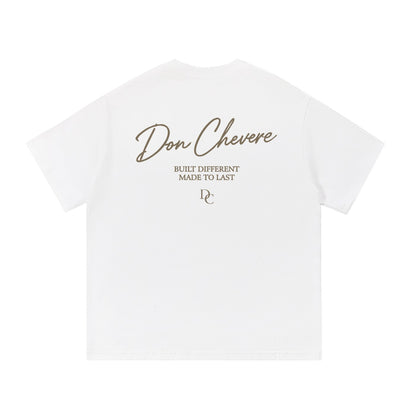 Don Chevere white 100% cotton t-shirt with gold text graphic on back. Short sleeves, crew neck.